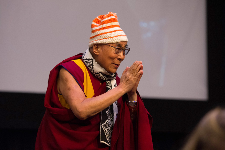His Holiness the Dalai Lama, wearing a cap and scarf presented by members of ISFiT thanking the students attending International Student Festival in Trondheim (ISFiT) at the conclusion of his talk at the Clarion Conference Centre in Trondheim, Norway on February 9, 2015. (Photo courtesy/foto.samfundet.no/OHHDL)