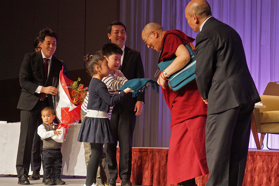 His Holiness the Dalai Lama being offered gifts of thanks at the conclusion of his talk in Sapporo, Japan on April 3, 2015. (Photo courtesy/Jeremy Russell/OHHDL)