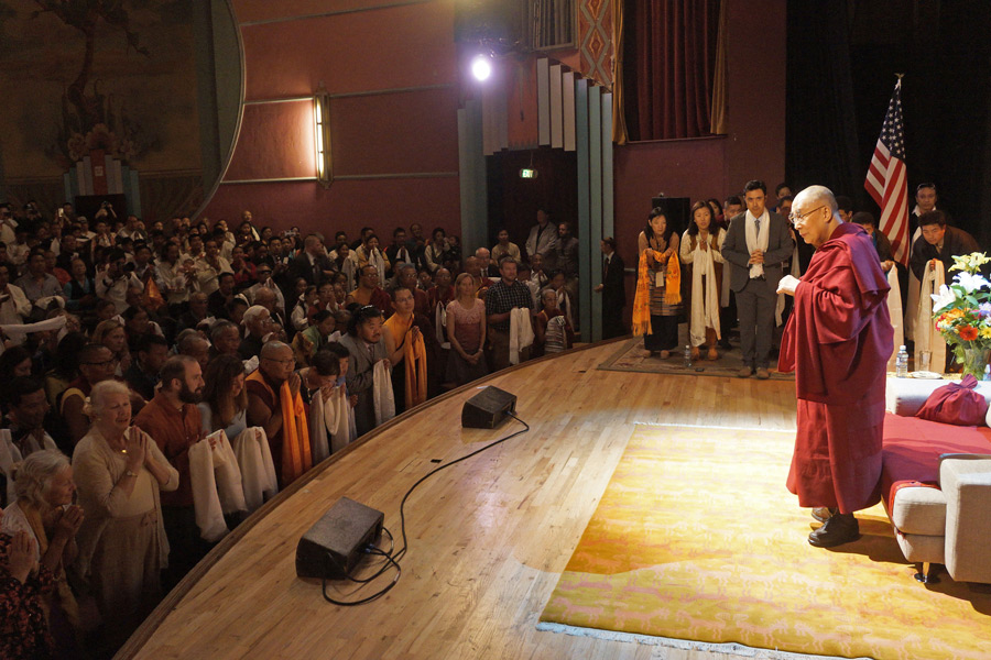 Audience members holding ceremonial white scarves as a token of respect as His Holiness arrives at the Boulder Theater in Boulder, Colorado on June 24, 2016. (Photo courtesy/Jeremy Russell/OHHDL)