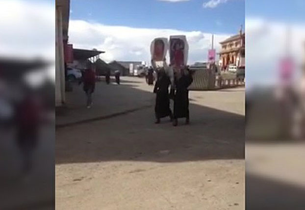 Two Tibetan women in Ngaba carry photos of the Dalai Lama in a public protest, Nov. 16, 2016. (Photo courtesy: RFA)