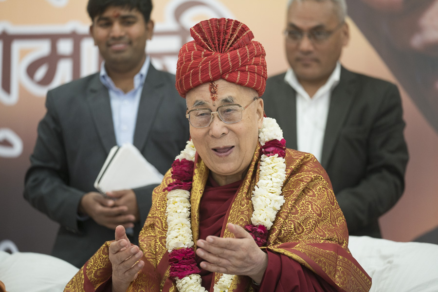 His Holiness the Dalai Lama wearing a turban (pagri) offered by Indian religious leaders as symbol of honor and respect during a program at Sri Udasin Karshni Ashram in Mathura, UP, India on March 21, 2017. (Photo courtesy: Tenzin Choejor/OHHDL)