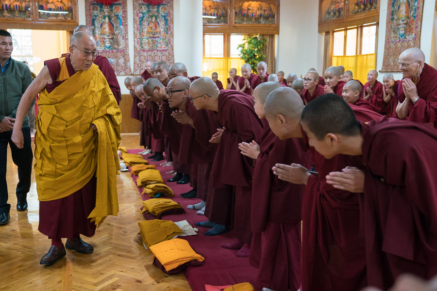 His Holiness the Dalai Lama greeting candidates for novice ordination as he arrives at the assembly hall at his residence in Dharamsala, HP, India on March 6, 2017. (Photo courtesy: Tenzin Choejor/OHHDL)