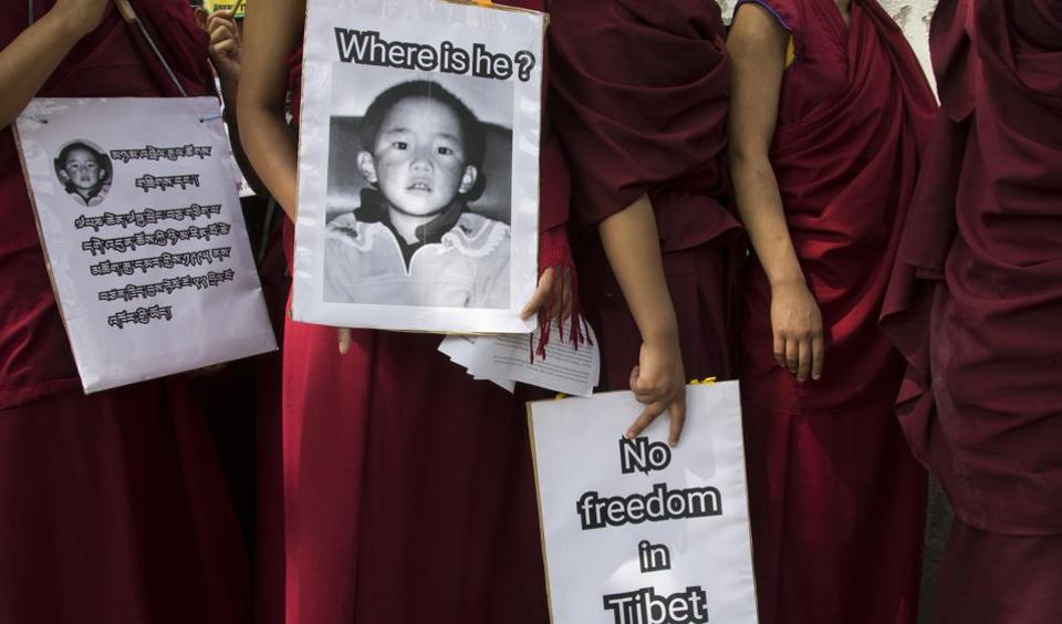 Buddhist nuns carry placards during a protest march demanding the release of religious leader Gedhun Choekyi Nyima, the 11th Panchen Lama, who was put under house arrest by the Chinese authorities on this day in 1995. Panchen Lama is the second most important religious leader in Tibetan Buddhism, after the Dalai Lama.  ( Photo courtesy: Ashwini Bhatia/AP)