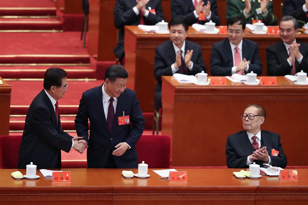 Chinese President Xi Jinping shakes hands with former President Hu Jintao as former President Jiang Zemin looks on during the opening session. (Photo courtesy: NBC News)