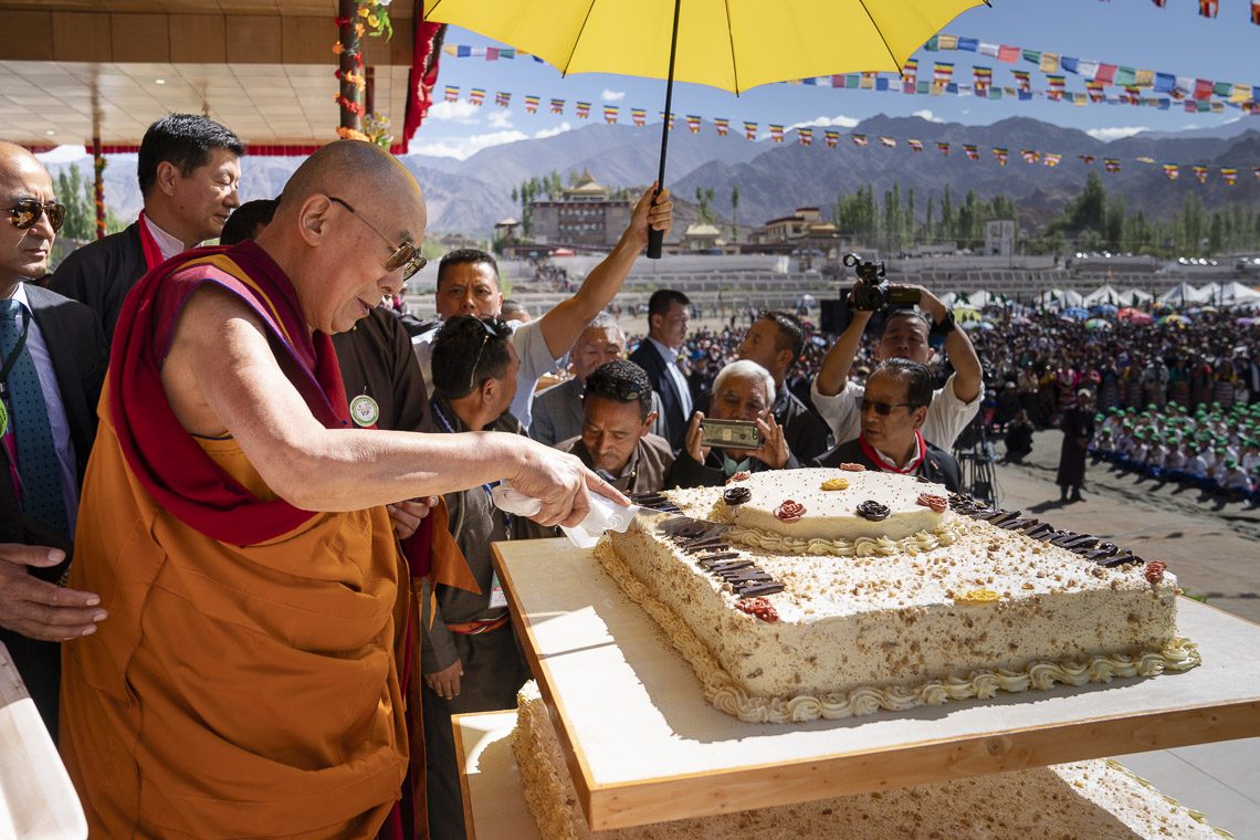 His Holiness the Dalai Lama cutting the cake during celebrations of his 83rd birthday at the Shiwatsel Teaching Ground in Leh, Ladakh, J&K, India on July 6, 2018. (Photo courtesy: OHHDL)